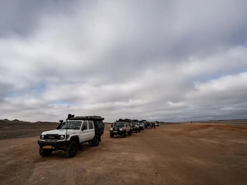 Vehicles on the beach at first light