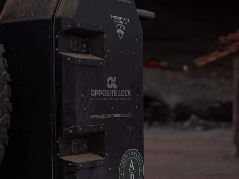 A storage case on the back of a vehicle, coated in dust
