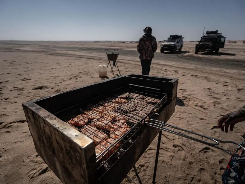 Cooking over coals on the beach at the end of a day