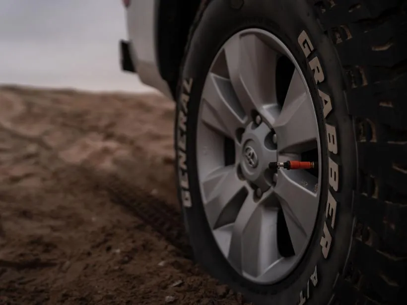 A tyre being deflated for sand